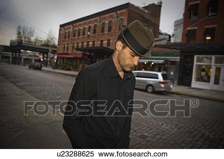 Man walking on city street View Large Photo Image Stock Photography - Man walking on city street. Fotosearch