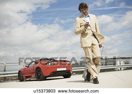 Man walking with trolley, electric car View Large Photo Image Stock Image - Man walking with trolley, electric car. Fotosearch