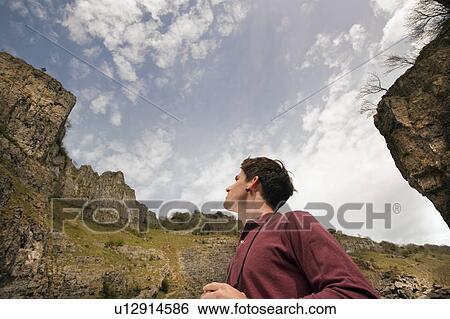Stock Photograph - Man with binoculars in valley. Fotosearch