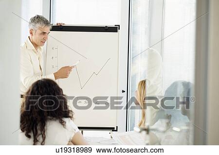Stock Photo - Man with flip-chart in office meeting. Fotosearch