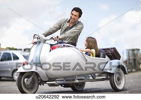 Man with girl driving a vespa View Large Photo Image Stock Image - Man with girl driving a vespa. Fotosearch