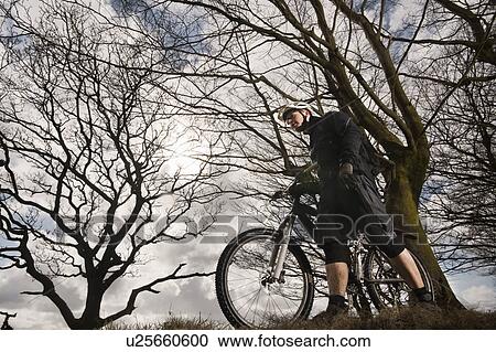 Man with mountain bike in countryside View Large Photo Image Stock Image - Man with mountain bike in countryside. Fotosearch