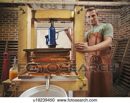 Man with organic cider press View Large Photo Image Stock Image - Man with organic cider press. Fotosearch