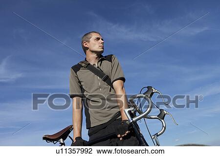 Man with road bike View Large Photo Image Stock Image - Man with road bike. Fotosearch