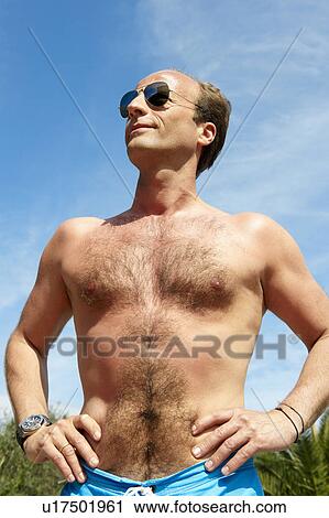 Man without his shirt, shot from below View Large Photo Image Stock Image - Man without his shirt, shot from below. Fotosearch