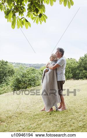 Mature couple embrace in park View Large Photo Image Picture - Mature couple embrace in park. Fotosearch