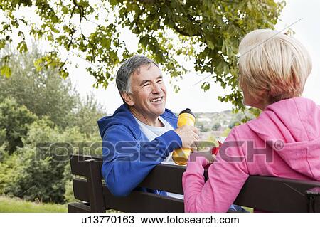 Stock Image - Mature couple having exercise break. Fotosearch