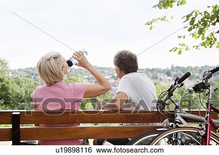 Mature couple having rest on parkbench View Large Photo Image Stock Photograph - Mature couple having rest on parkbench. Fotosearch