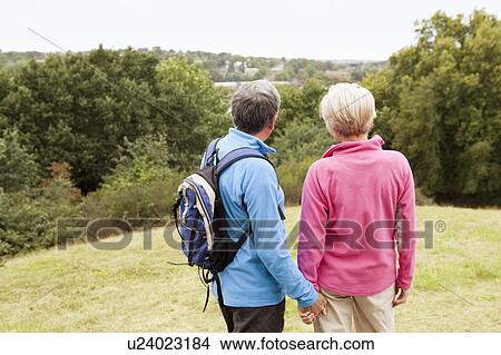 Picture - Mature couple looking out over valley. Fotosearch