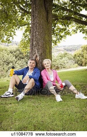 Stock Photo - Mature couple resting after exercise. Fotosearch