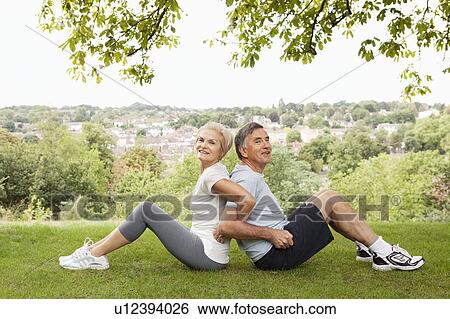 Mature couple stretching back to back View Large Photo Image Stock Photograph - Mature couple stretching back to back. Fotosearch