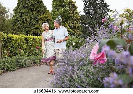 Mature couple walking in rose garden View Large Photo Image Stock Photography - Mature couple walking in rose garden. Fotosearch