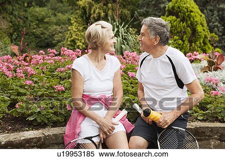 Stock Photography - Mature tennisplayers talking in park. Fotosearch