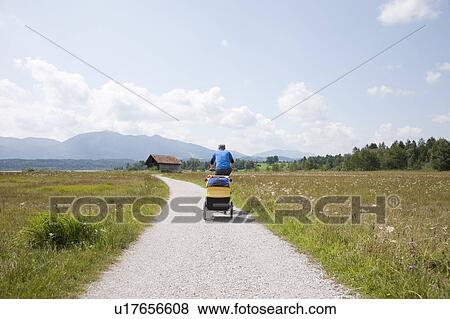 Men cycling with trailer View Large Photo Image Stock Photo - Men cycling with trailer. Fotosearch