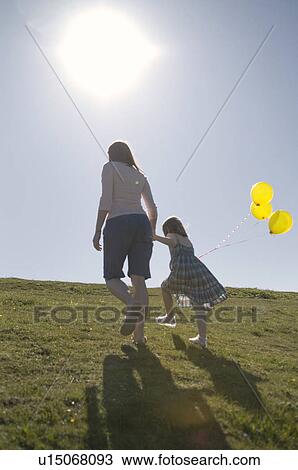 Mother and child with balloons on hill View Large Photo Image Stock Image - Mother and child with balloons on hill. Fotosearch