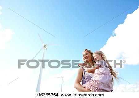 Picture - Mother and daughter at wind turbine. Fotosearch