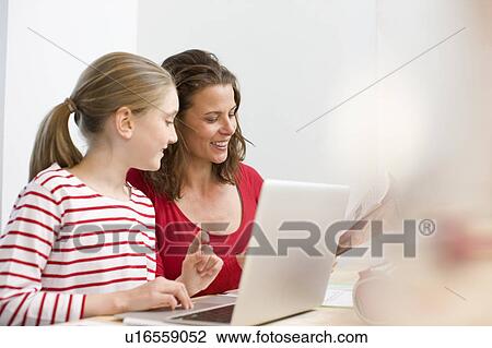 Mother and daughter doing homework View Large Photo Image Stock Image - Mother and daughter doing homework. Fotosearch