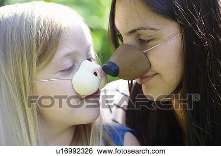 Mother and daughter wearing masks View Large Photo Image Stock Photograph - Mother and daughter wearing masks. Fotosearch