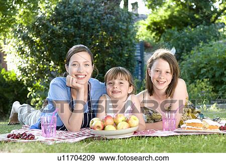 Mother and daughters at picnic View Large Photo Image Stock Photo - Mother and daughters at picnic. Fotosearch