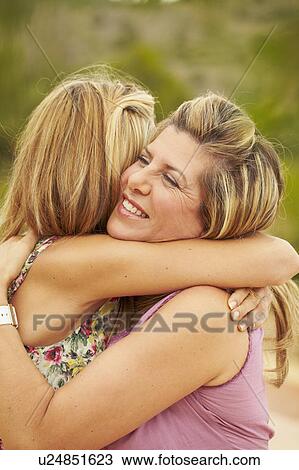 Mother and grown-up daughter embracing View Large Photo Image Stock Image - Mother and grown-up daughter embracing. Fotosearch