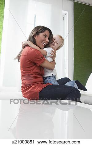 Mother and son hugging each other View Large Photo Image Stock Image - Mother and son hugging each other. Fotosearch