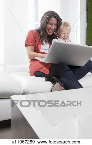 Stock Photo - Mother and son using laptop. Fotosearch