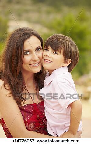 Stock Photo - Mother and young son hugging each other. Fotosearch