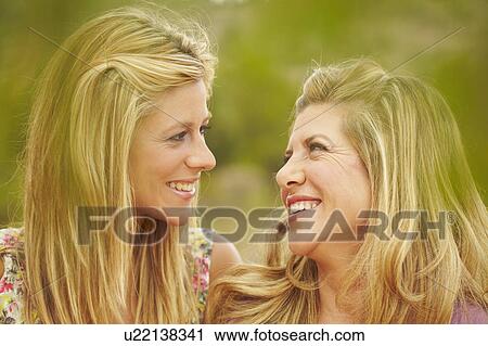Mother & daughter smiling at each other View Large Photo Image Stock Image - Mother & daughter smiling at each other. Fotosearch