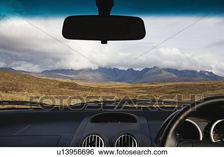 Stock Photograph - Mountains seen through car windscreen. Fotosearch