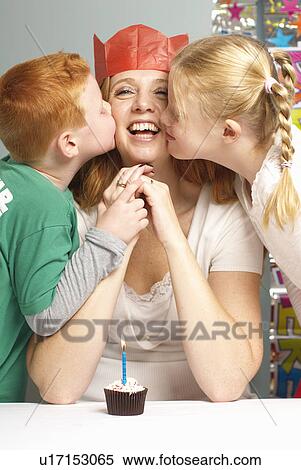 Stock Photography - Mum being kissed by her children. Fotosearch