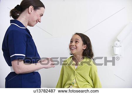 Nurse and young girl smiling View Large Photo Image Stock Photo - Nurse and young girl smiling. Fotosearch