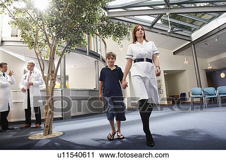 Nurse with boy in waiting area View Large Photo Image Stock Image - Nurse with boy in waiting area. Fotosearch