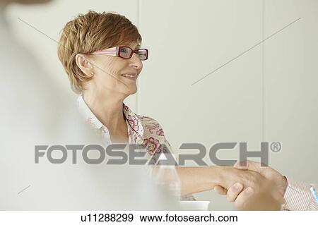 Older business woman shaking hands View Large Photo Image Stock Photo - Older business woman shaking hands. Fotosearch
