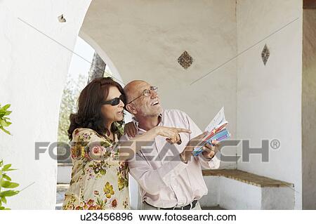 Older couple consulting guidebooks View Large Photo Image Stock Photograph - Older couple consulting guidebooks. Fotosearch