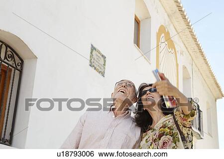 Older couple looking at attractions View Large Photo Image Stock Photograph - Older couple looking at attractions. Fotosearch