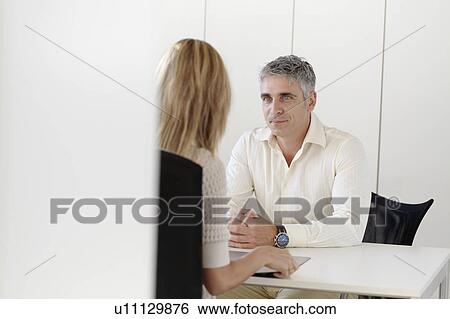 Older man interviewing young woman View Large Photo Image Stock Photograph - Older man interviewing young woman. Fotosearch