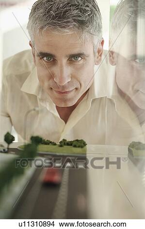 Older man with architectural model View Large Photo Image Picture - Older man with architectural model. Fotosearch