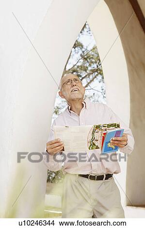 Older man with guidebooks View Large Photo Image Picture - Older man with guidebooks. Fotosearch
