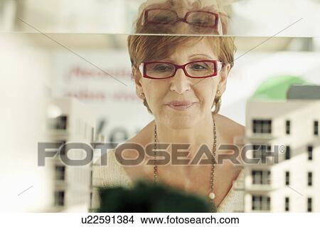 Picture - Older woman with architectural model. Fotosearch
