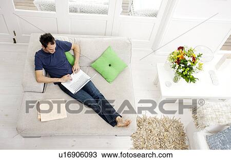 Overhead shot of man with laptop View Large Photo Image Stock Image - Overhead shot of man with laptop. Fotosearch
