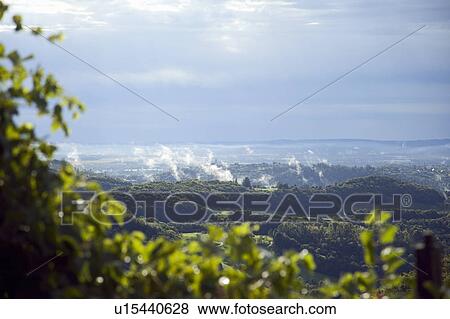 Overlooking a misty valley View Large Photo Image Stock Photo - Overlooking a misty valley. Fotosearch