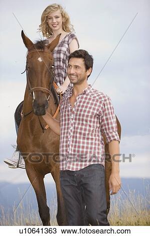 Stock Image - People and horses. Fotosearch