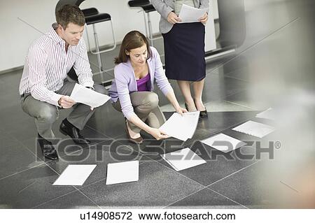 People working on a presentation View Large Photo Image Stock Image - People working on a presentation. Fotosearch