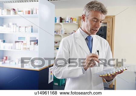 Pharmacist counting pills View Large Photo Image Stock Photo - Pharmacist counting pills. Fotosearch