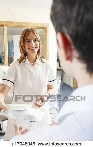 Pharmacist handing over prescription View Large Photo Image Stock Photograph - Pharmacist handing over prescription. Fotosearch