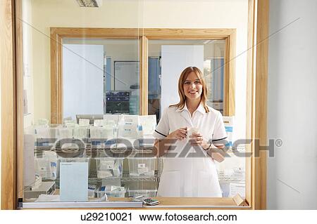 Pharmacist relaxing with a hot drink View Large Photo Image Stock Image - Pharmacist relaxing with a hot drink. Fotosearch