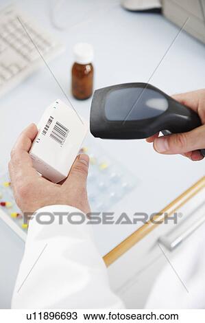 Pharmacist scanning pill box View Large Photo Image Stock Image - Pharmacist scanning pill box. Fotosearch