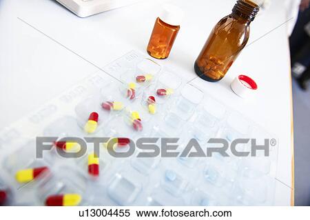 Pills laid out on desk View Large Photo Image Stock Photography - Pills laid out on desk. Fotosearch