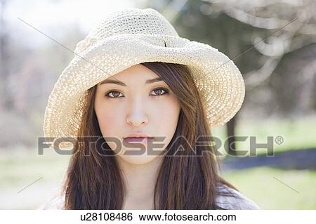 Stock Photograph - Portrait of a girl wearing a hat. Fotosearch