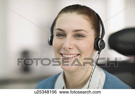 Stock Photograph - Portrait of a young receptionist. Fotosearch